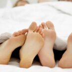 footsies couple feet in bed